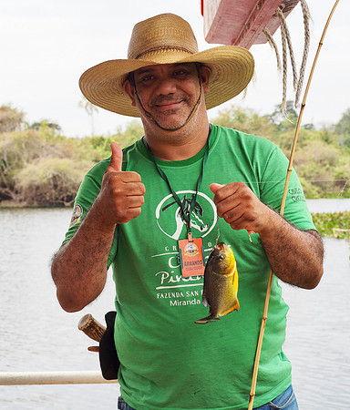 Armando holding a piranha he pulled from the river